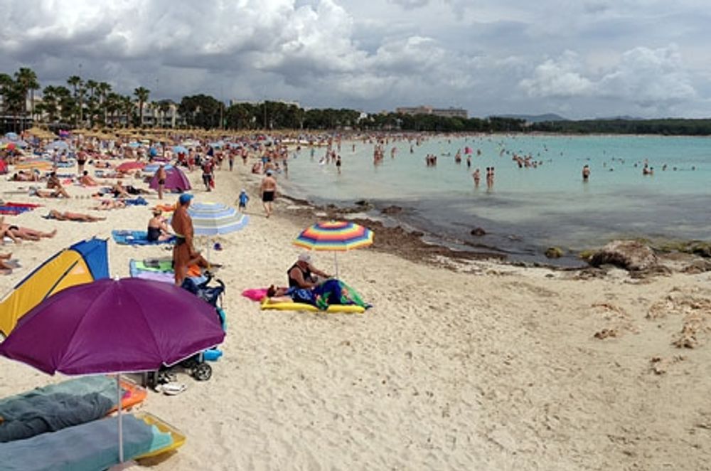Turister p&aring; stranden i Sa Coma (Mallorca).