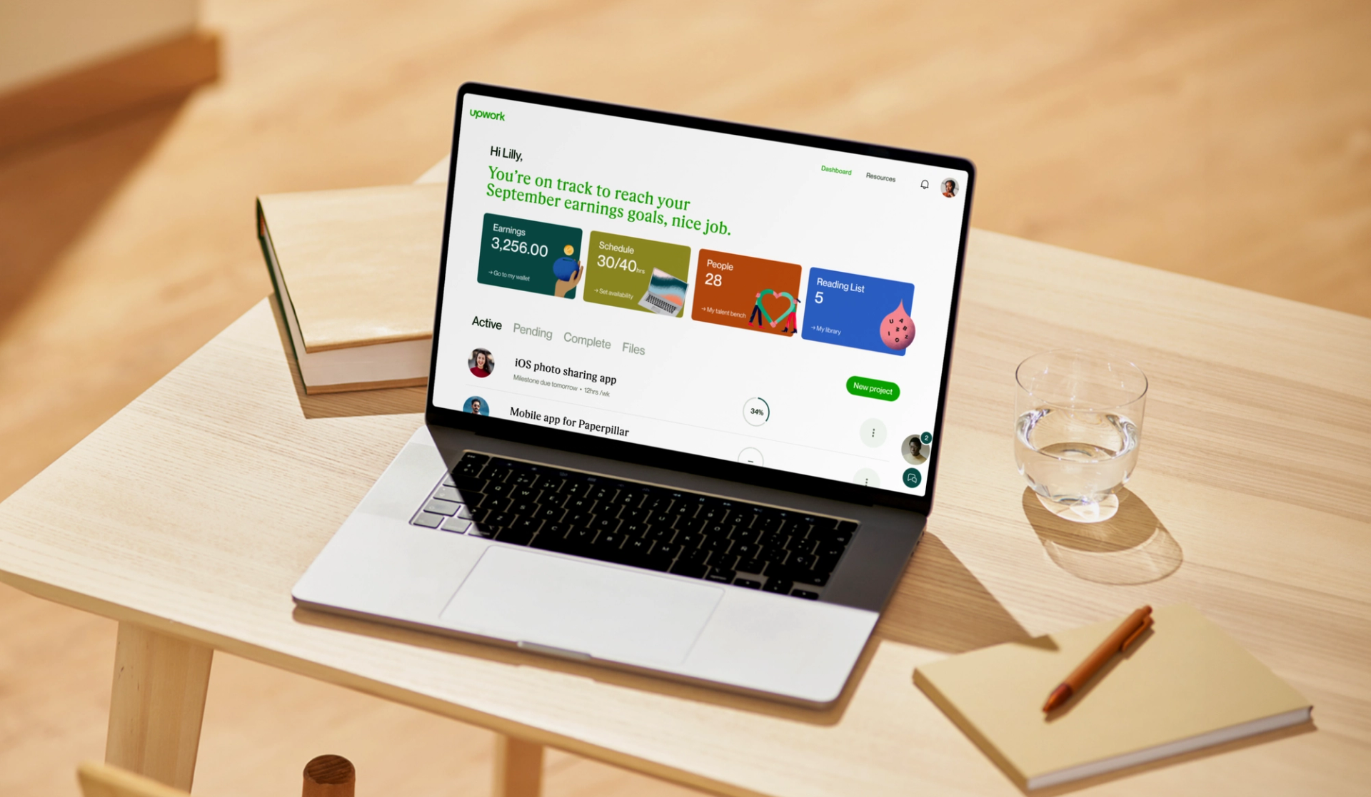 A laptop with Upwork site open on a desk