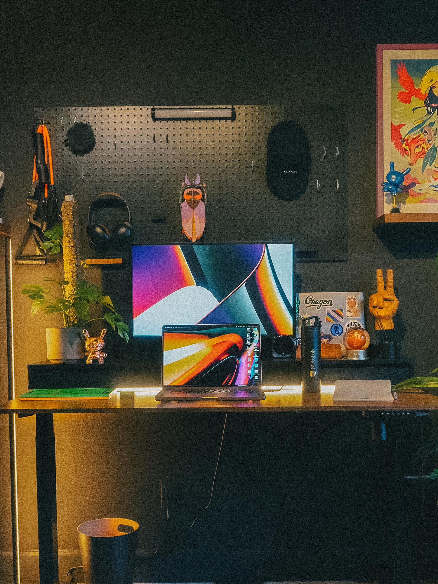 A remote desk set up with colourful background imagery and decor