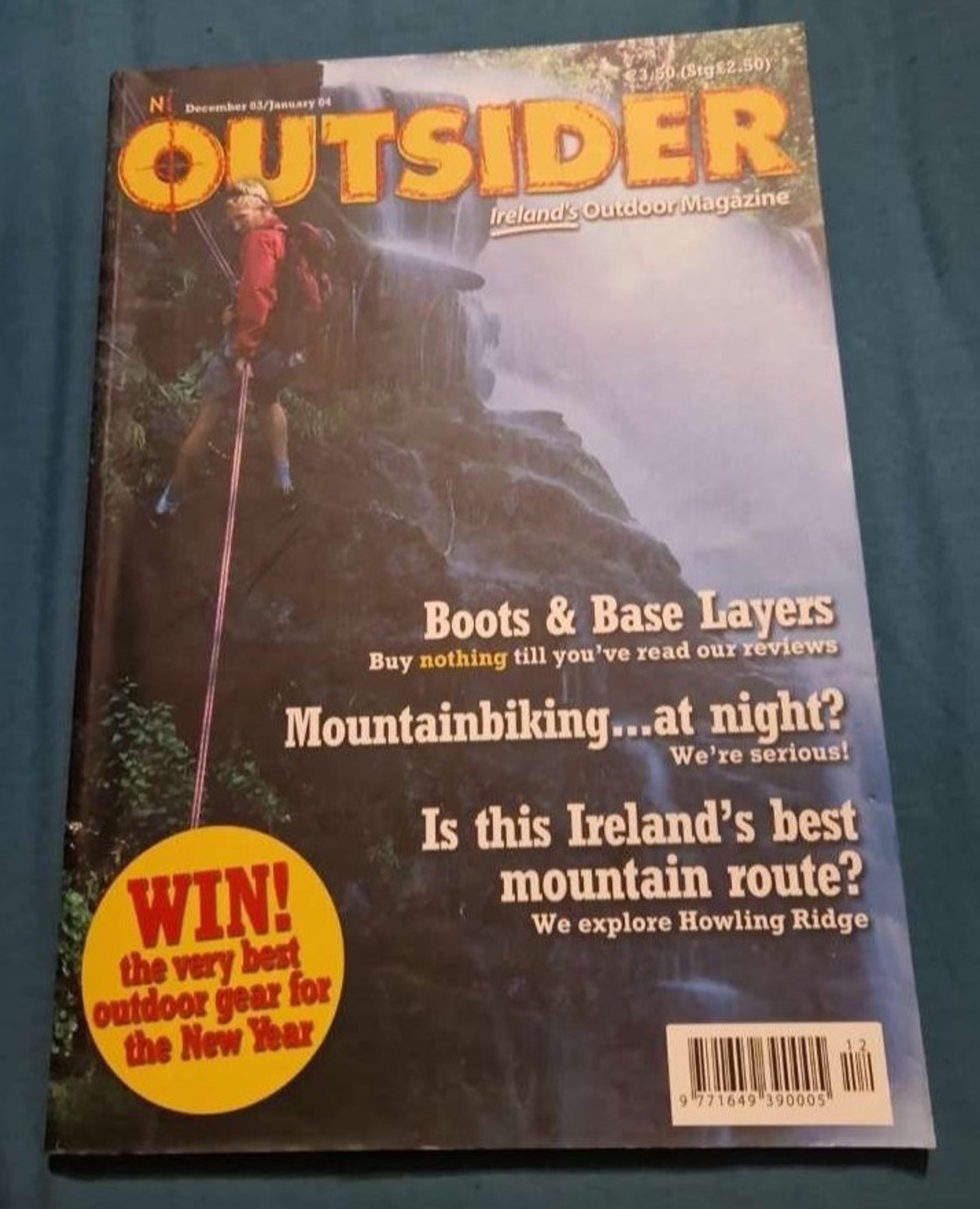 Cover of Outsider magazine, December 2003 / January 2004: a climber abseiling a wet cliff beside a waterfall.