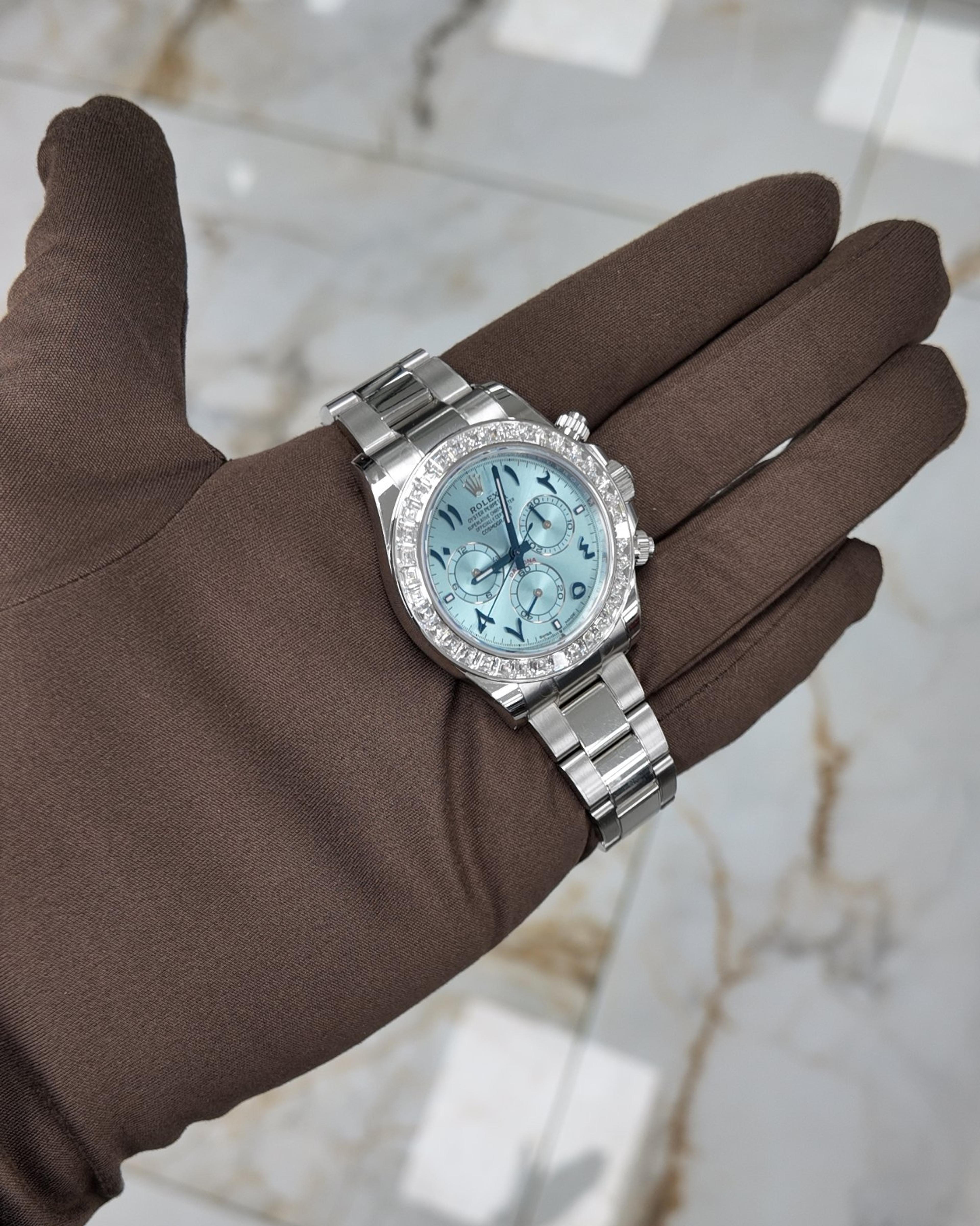 Platinum Rolex Daytona with an ice blue dial, on a gloved hand
