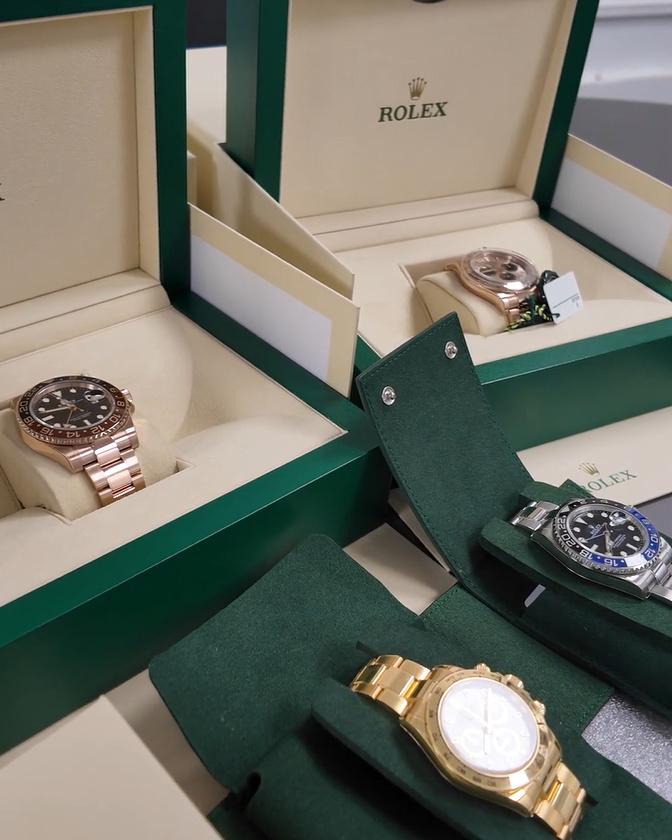 Protected watches back in their presentation boxes and green travel pouches