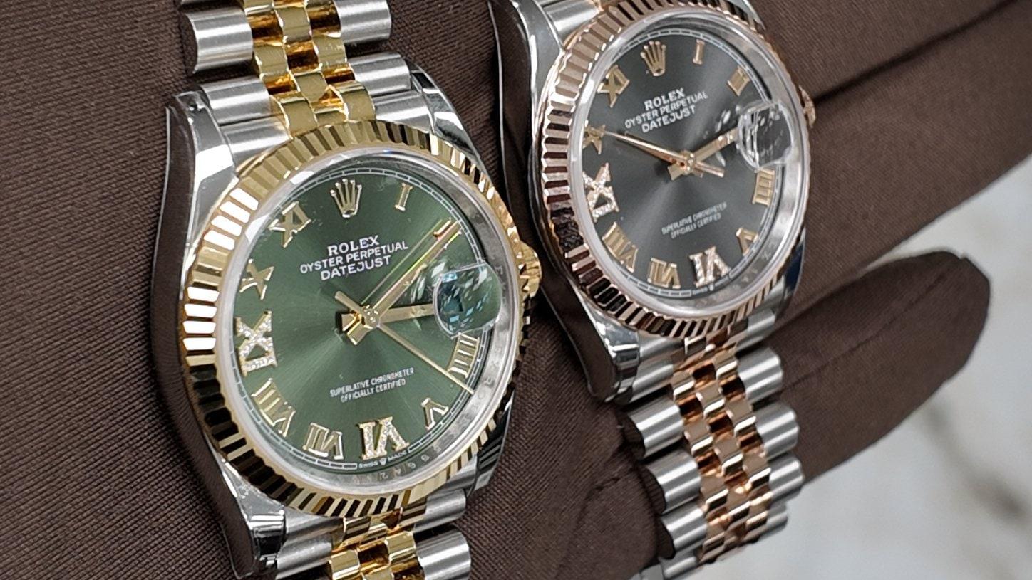 Two two-tone Rolex Datejusts on Jubilee bracelets, on a gloved hand
