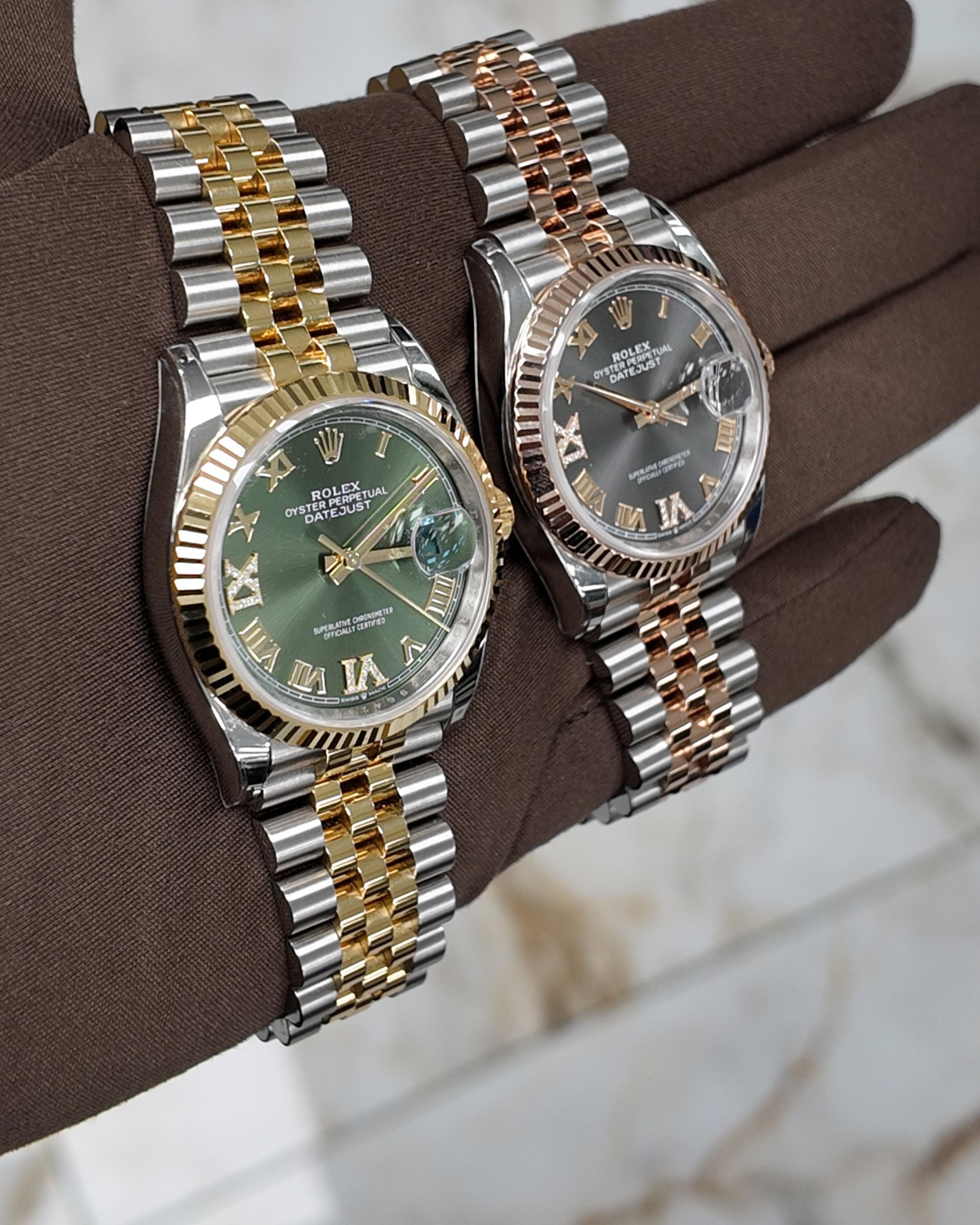 Two two-tone Rolex Datejusts on Jubilee bracelets, on a gloved hand