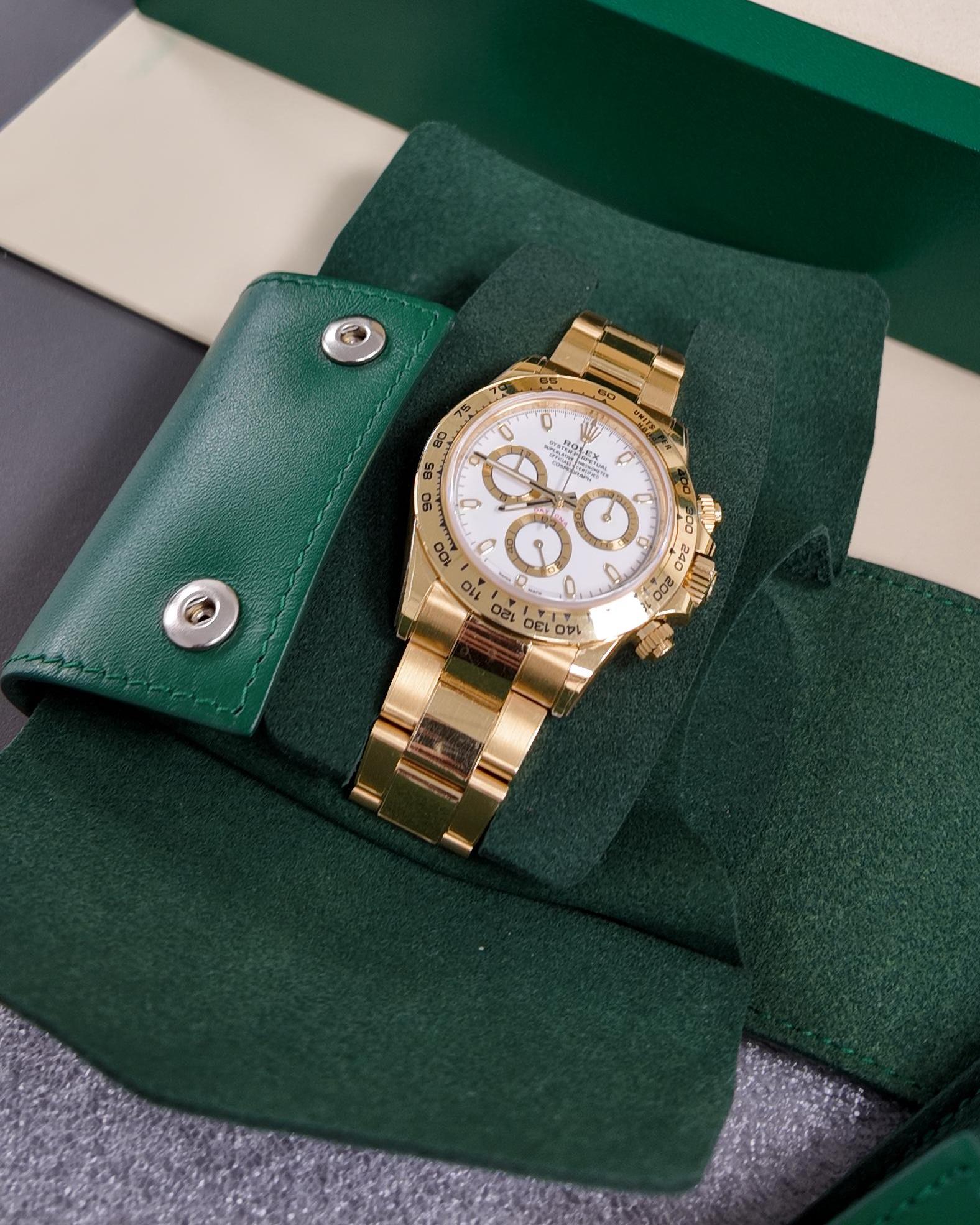 Yellow gold Rolex Daytona with a white dial, in its travel pouch