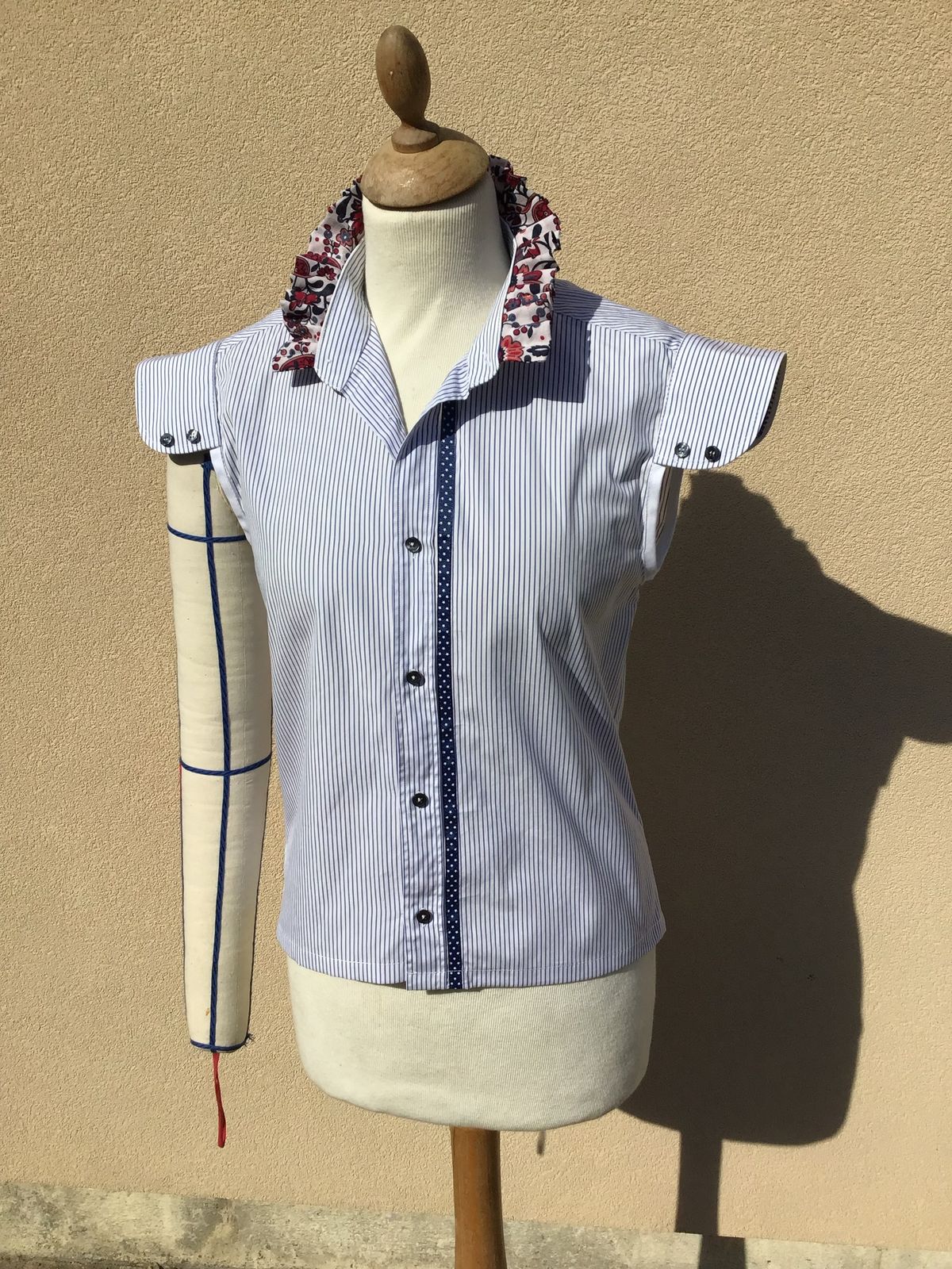 Chemisier rayé bleu et blanc à col fleuri sur mannequin