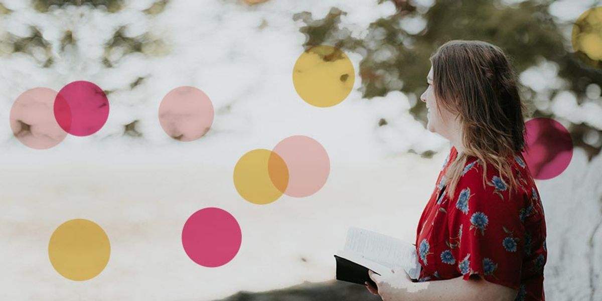 Woman in a red floral dress standing outdoors and looking into the distance while holding an open book, with colorful circles overlaid on the image.