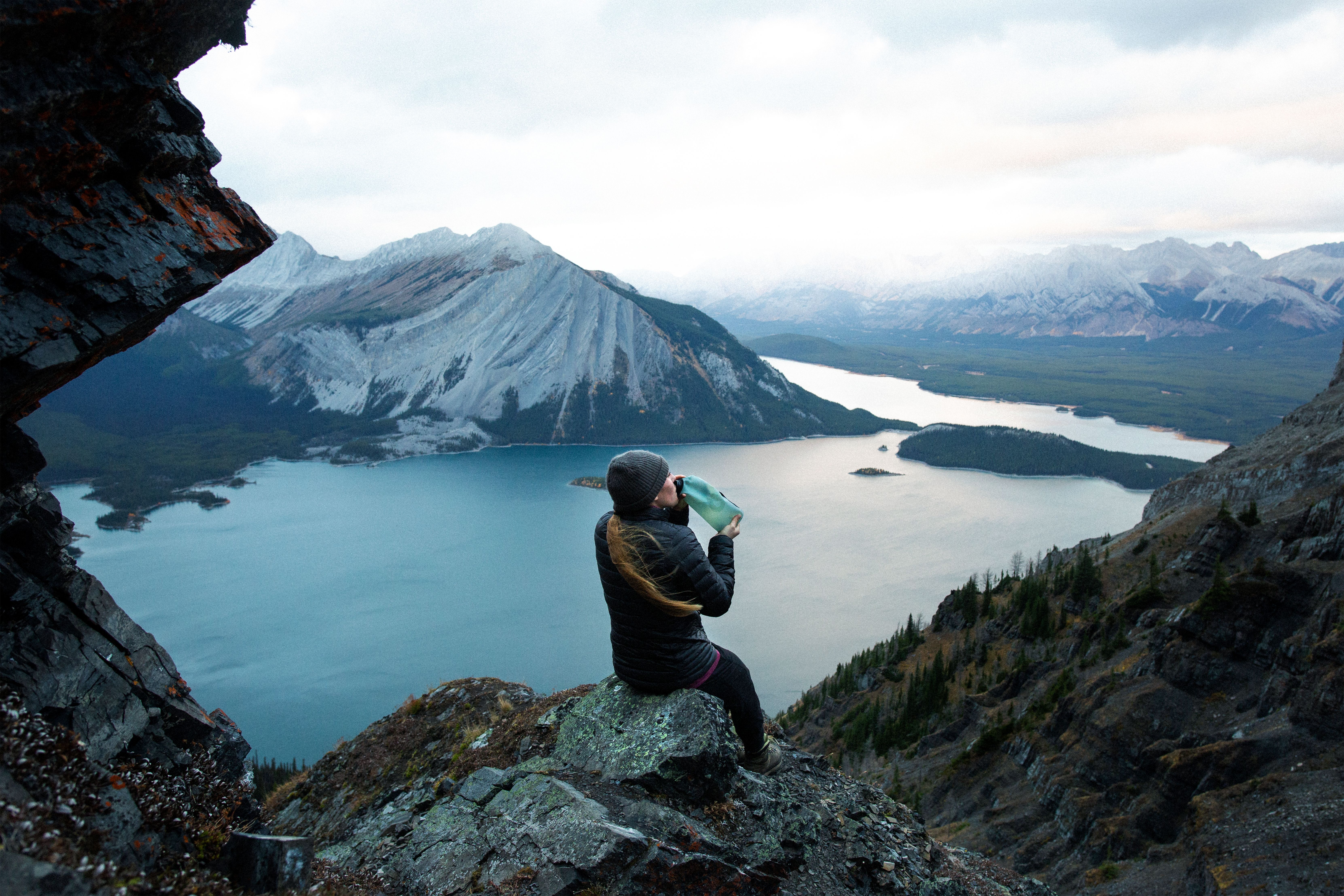 Woman in mountains drinking from Hydrapak flask