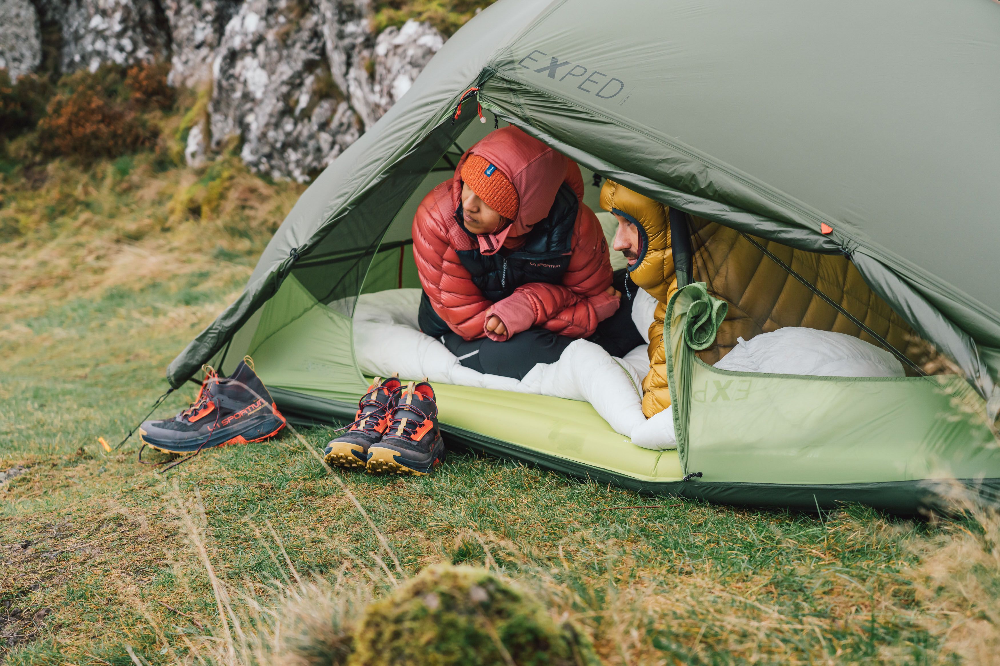 Hikers in their tent and sleeping bags