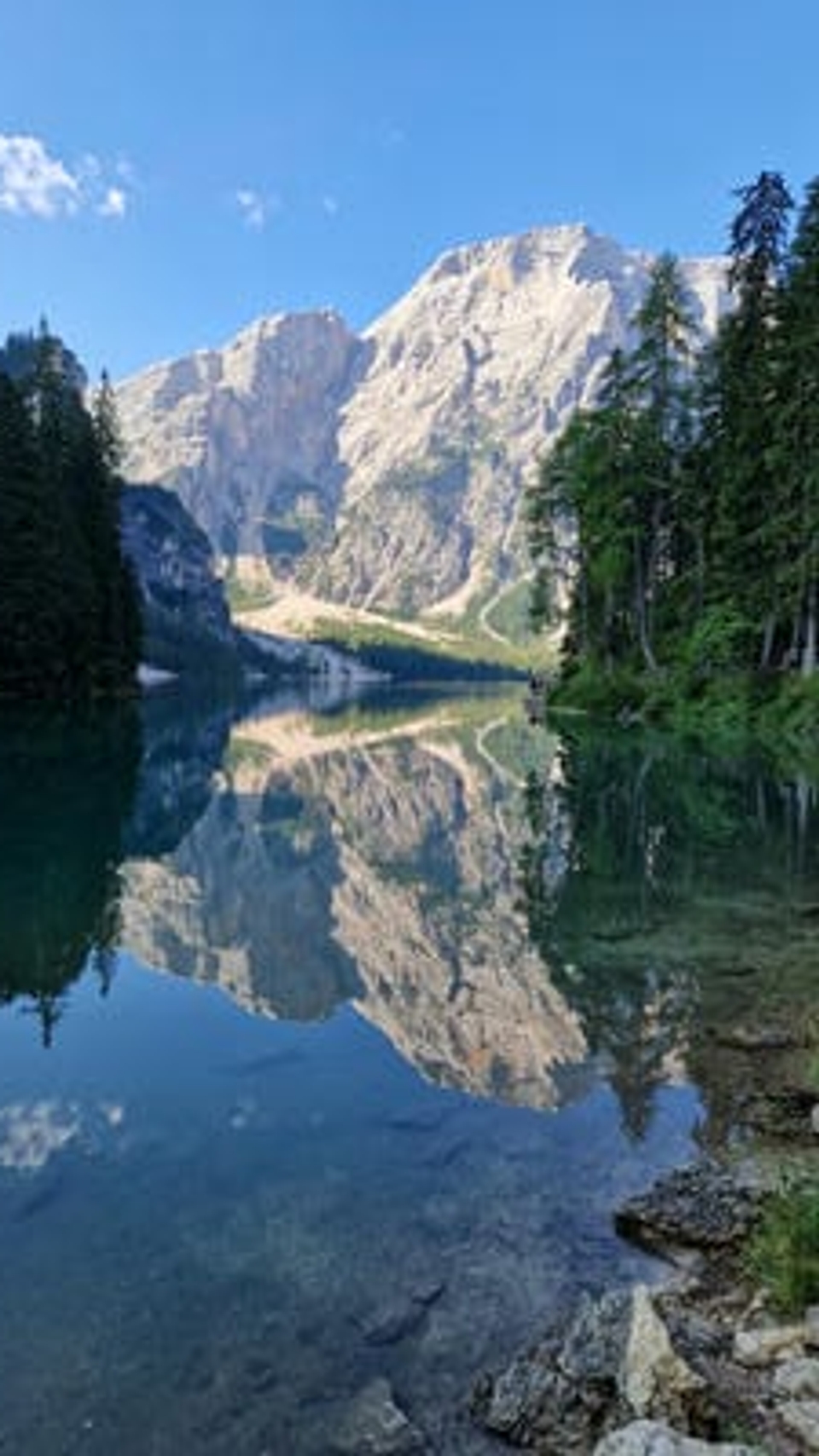 Good copy should clearly reflect your brand's values and personality, just like the still waters of this alpine lake reflecting the peaks, woodland and blue sky.