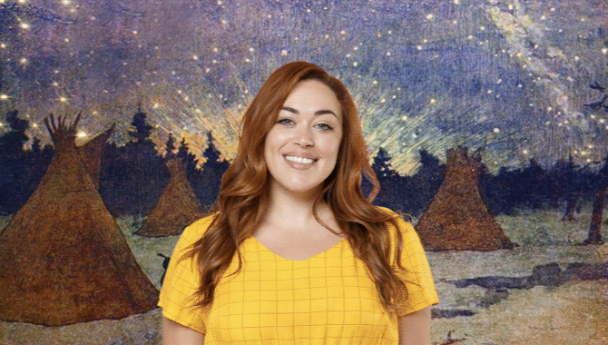Woman in yellow shirt in front of drawing of teepees and falling star sky