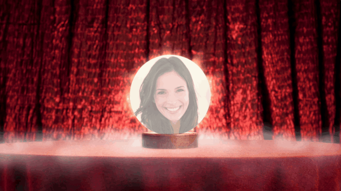 Person inside crystal ball against red curtains