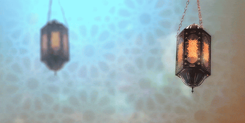 Glass and metal lanterns swinging against Girih pattern