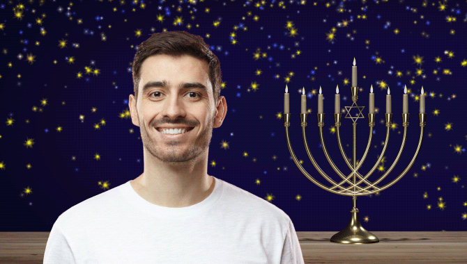 Man to the left of a menorah with stars twinkling in the background