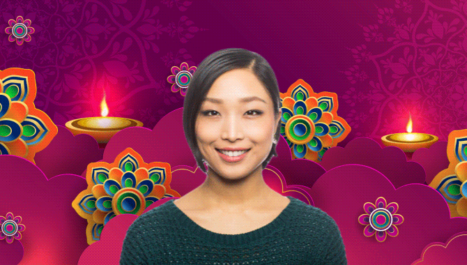 Woman in front of a Diwali graphic with flowers and magenta background