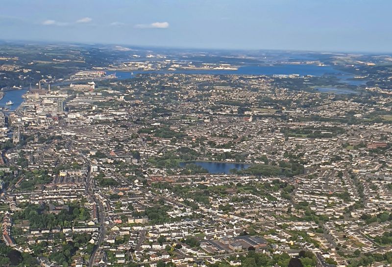 Aerial view over Cork city with The Lough pond, the docks and Cork Harbour in the distance