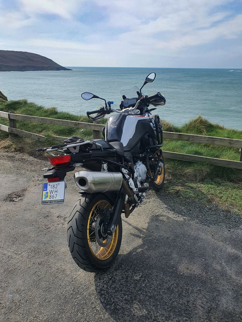 BMW F850GS adventure bike parked at a coastal viewpoint overlooking the Atlantic