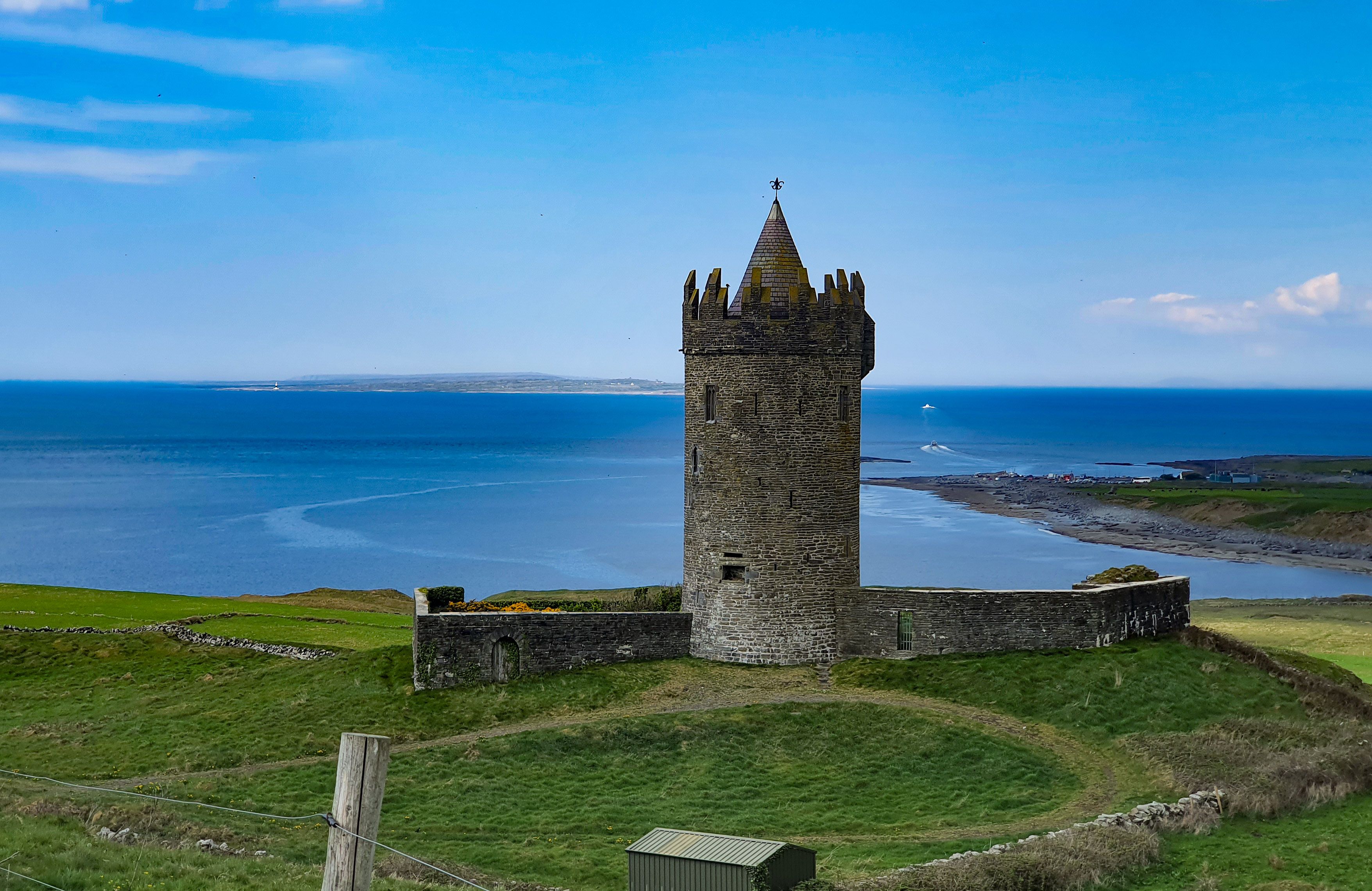 Doonagore Castle above Doolin, County Clare, with the bay beyond