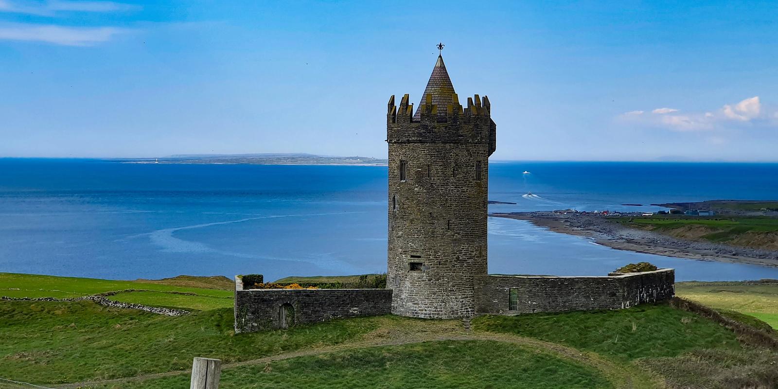 Doonagore Castle above Doolin, County Clare, with the bay beyond