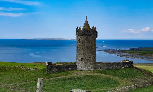 Doonagore Castle above Doolin, County Clare, with the bay beyond