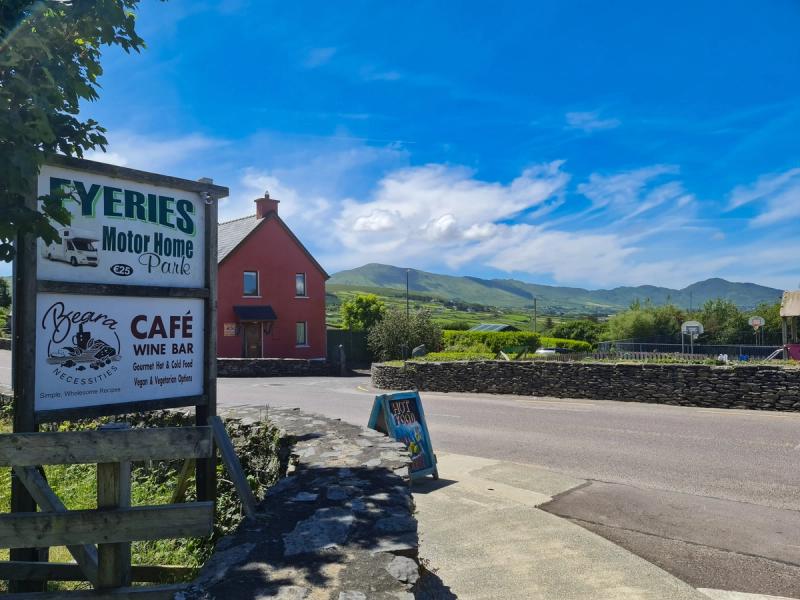 Café and motorhome park signs at the entrance to Eyeries village, Beara Peninsula
