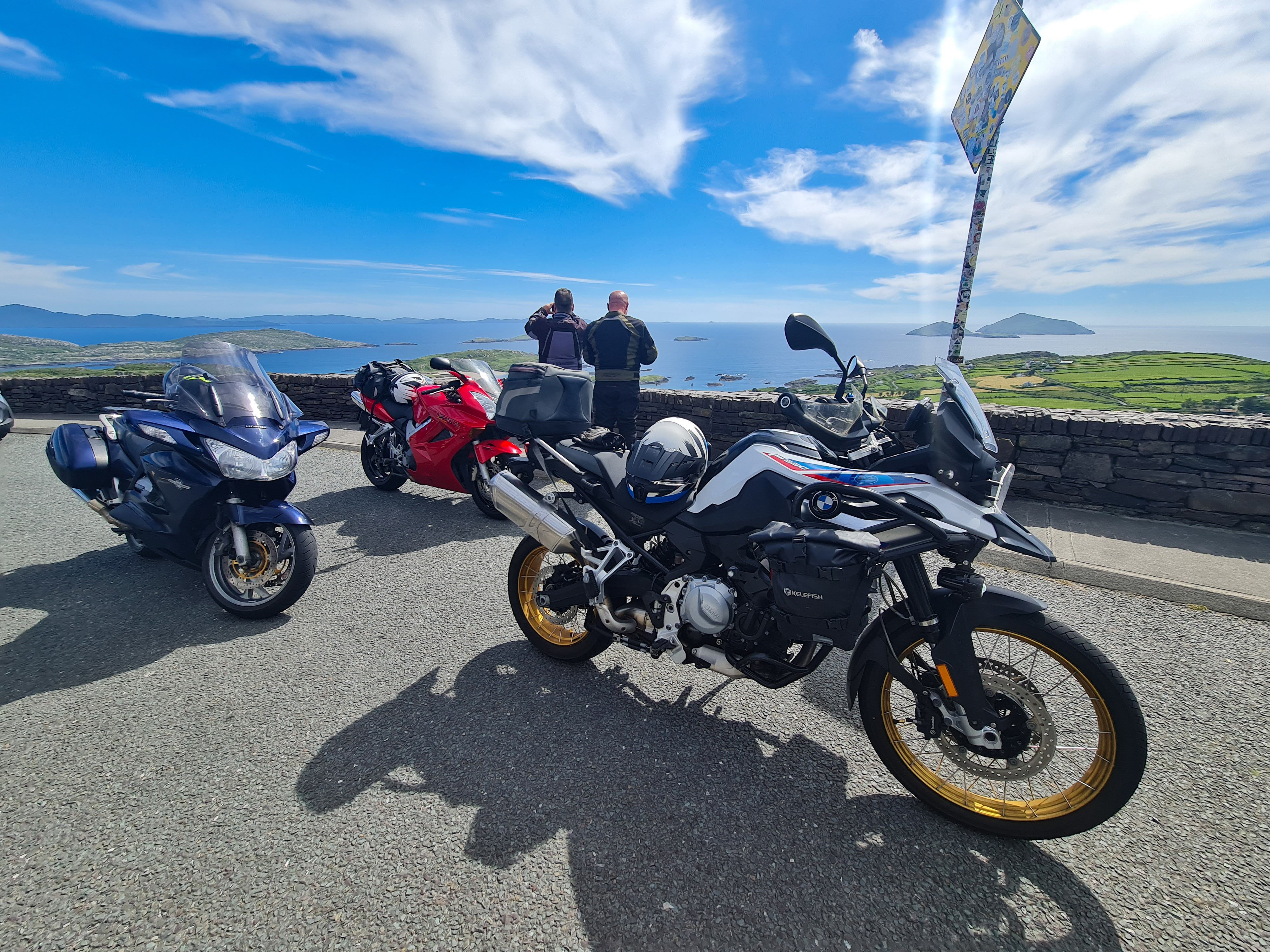Motorcycles parked at the Coomakista Pass viewpoint over Derrynane Bay