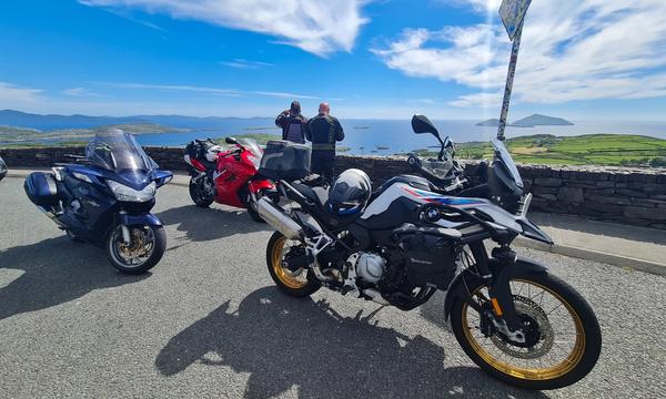 Motorcycles parked at the Coomakista Pass viewpoint over Derrynane Bay