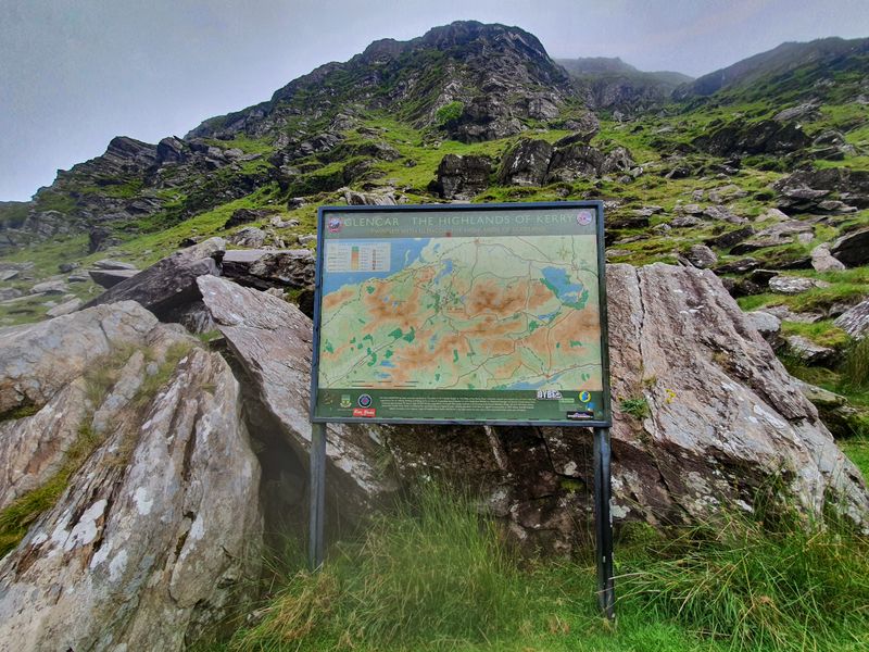 Glencar Highlands of Kerry information map board beneath rocky mountain slopes