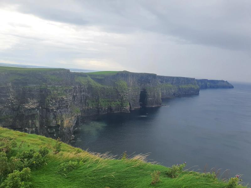 Cliffs of Moher stretching along the County Clare coast under a moody grey sky