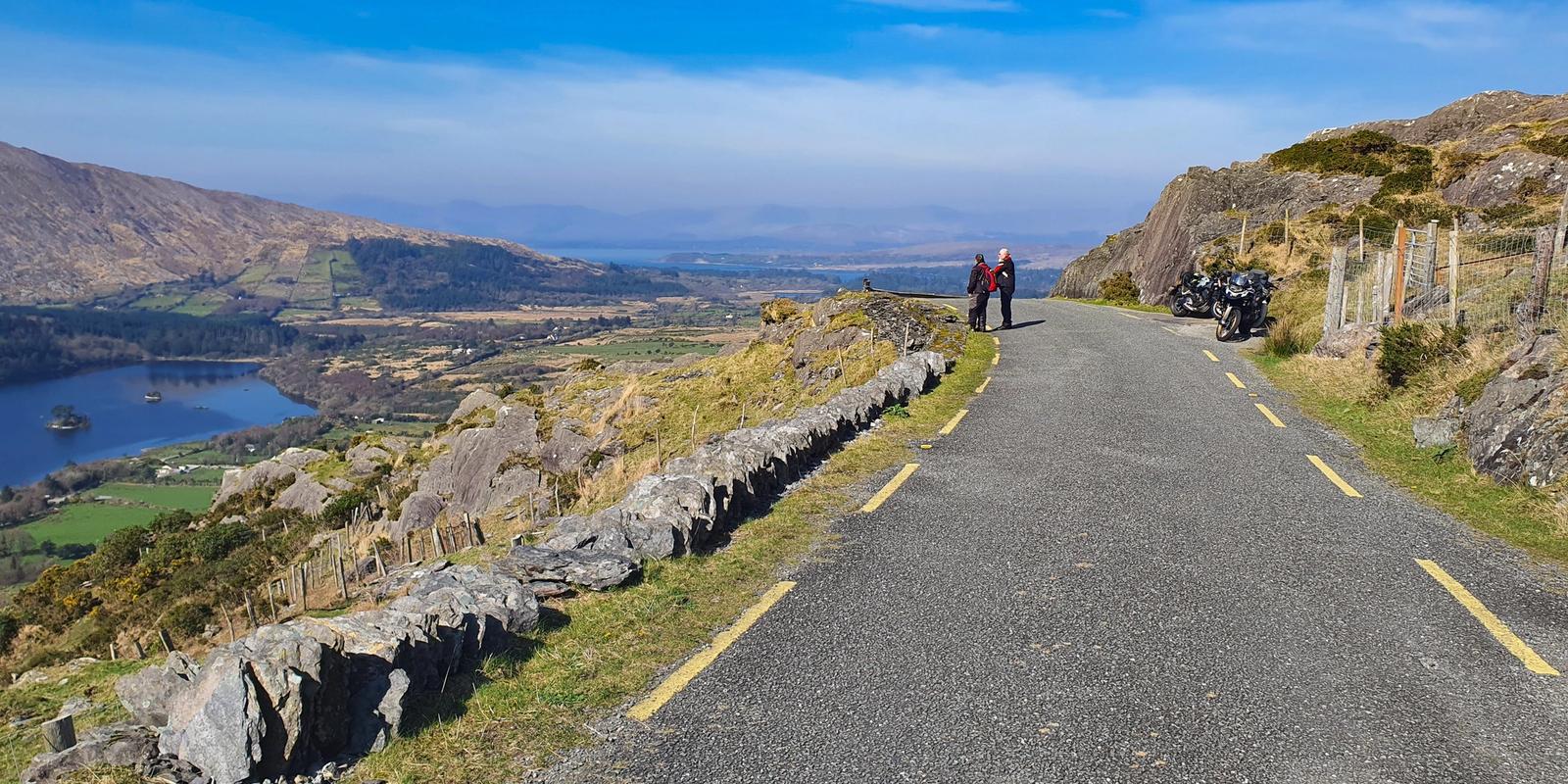 Riders take in the view over Glanmore Lake at the top of the Healy Pass