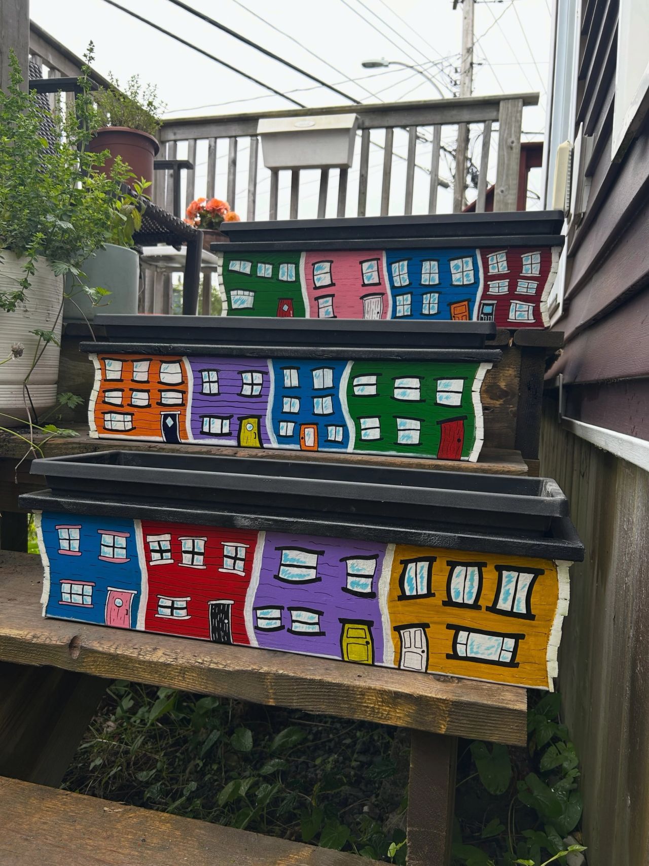 Three jellybean row planters sitting on a staircase
