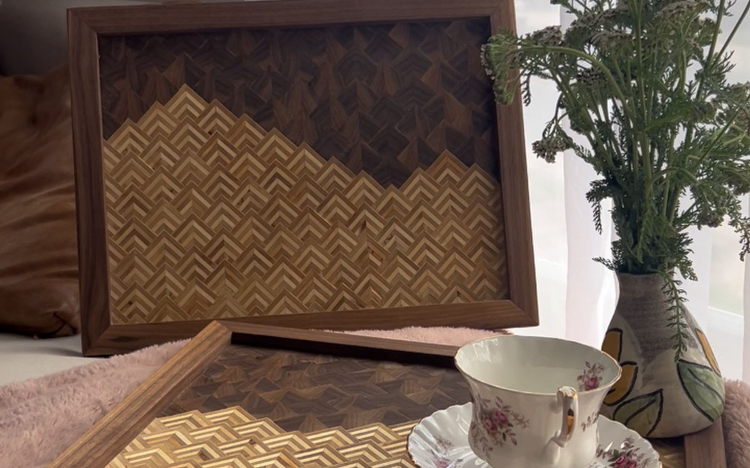 Pair of walnut-framed serving trays with a two-tone herringbone mountain pattern