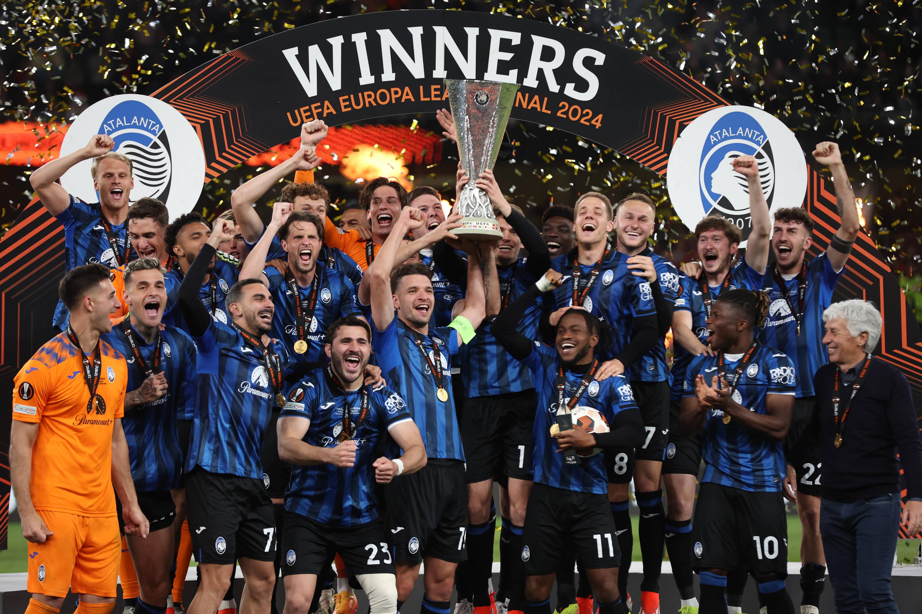 Atalanta players lift the UEFA Europa League trophy after defeating Bayer Leverkusen in the 2024 final.