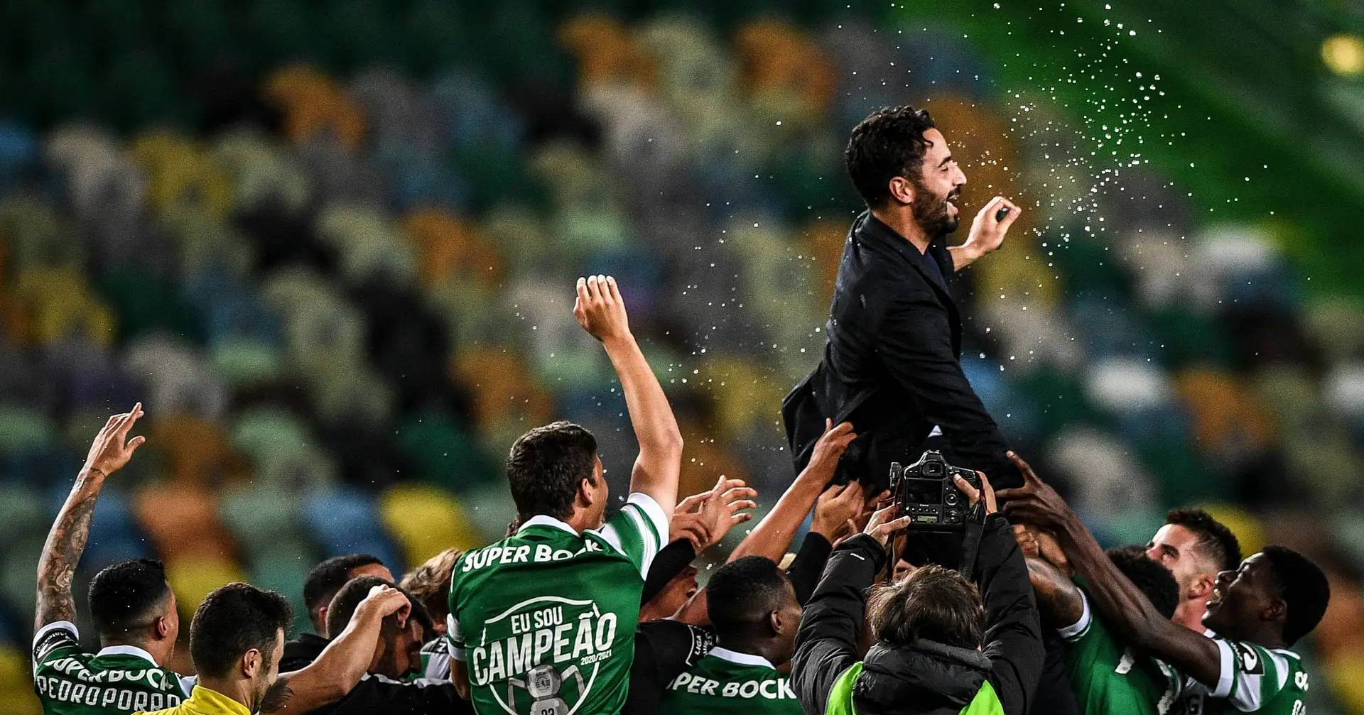 Rúben Amorim is lifted by his Sporting players after ending the club’s 19-year wait for a Portuguese league title in 2021.