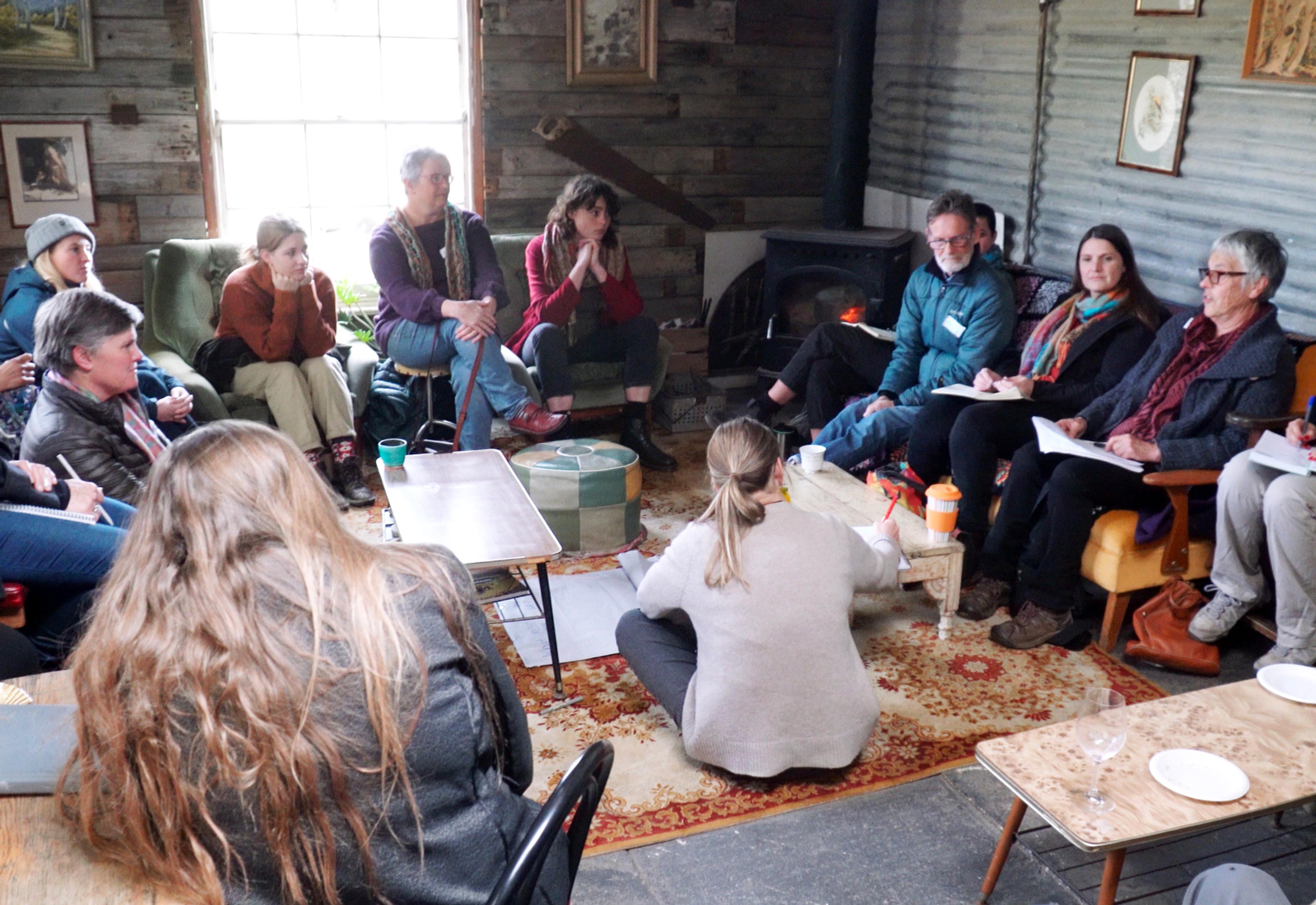 People talking in a circle inside a cellar door room.