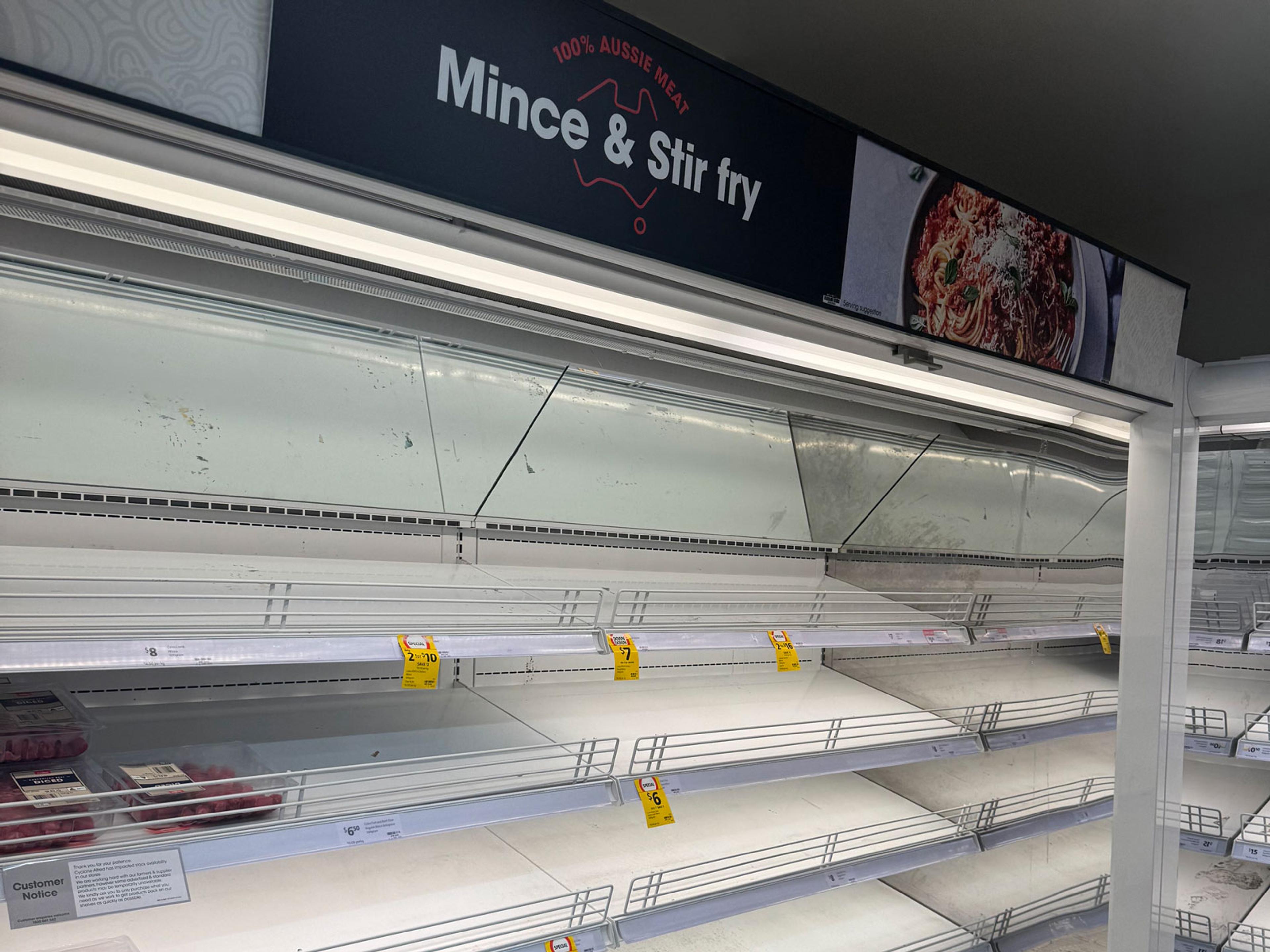 An almost empty supermarket meat fridge.