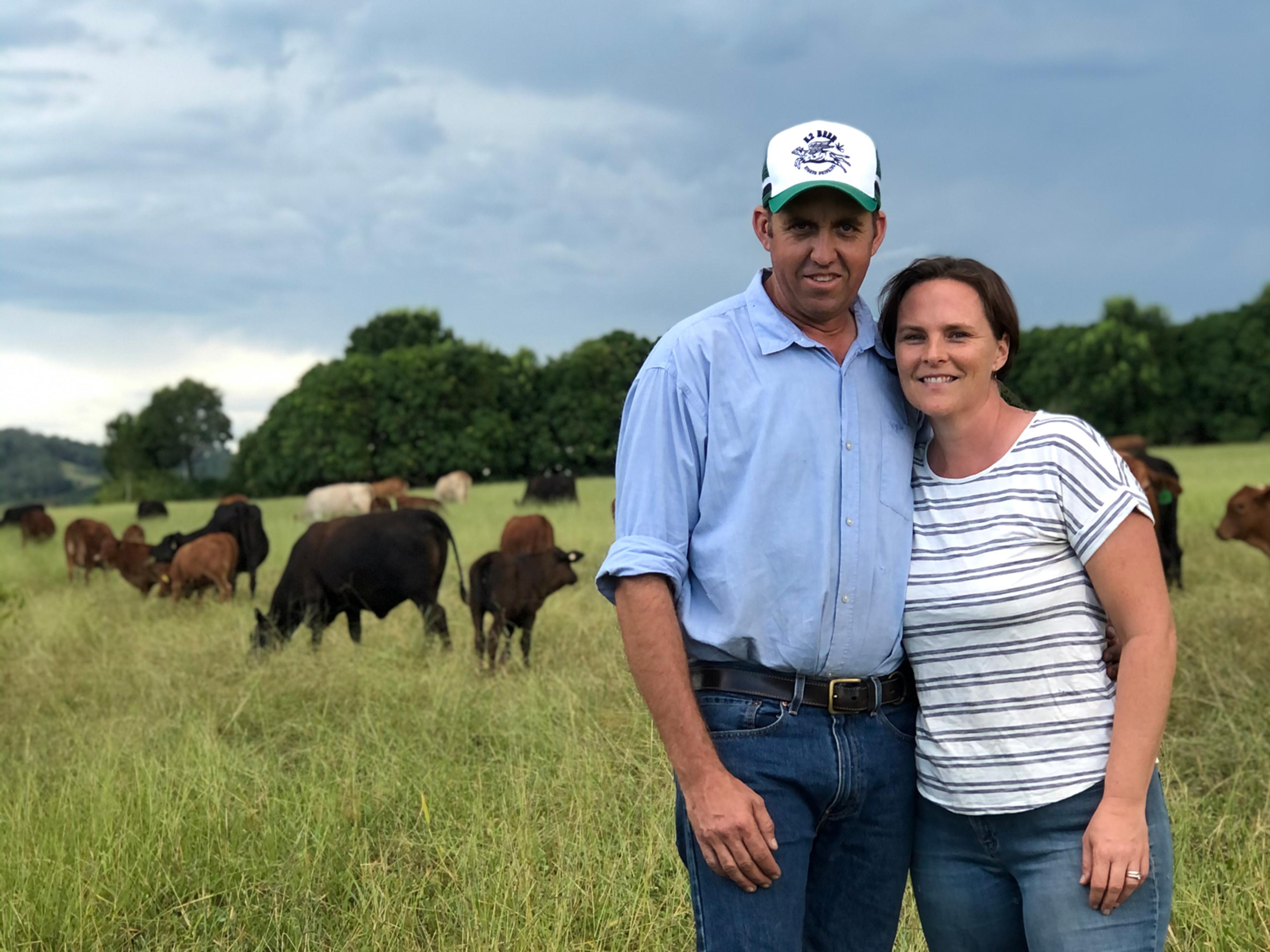 Founders Tim & Amber Scott on their Mary Valley property, Kandanga Farm, with their certified organic beef herd in the background.