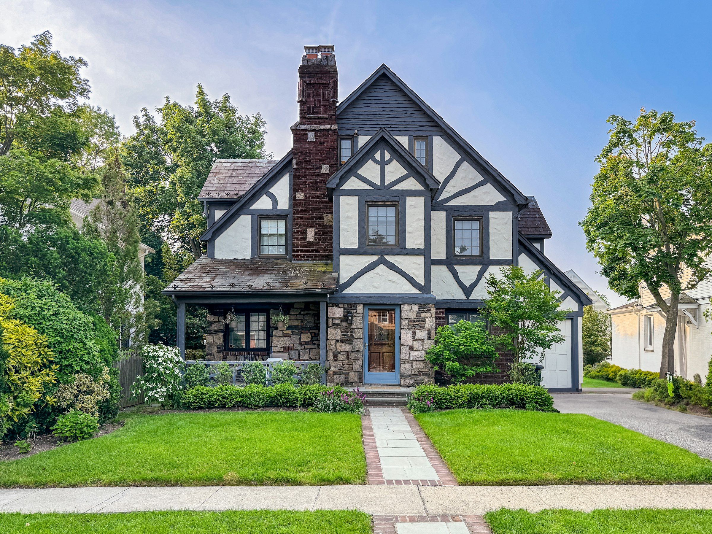 Tudor-style home with a stone porch and brick front walk, the kind of house Birmingham buyers can take their time on now