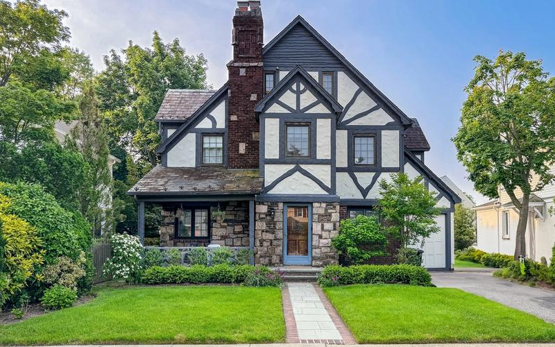 Tudor-style home with a stone porch and brick front walk, the kind of house Birmingham buyers can take their time on now