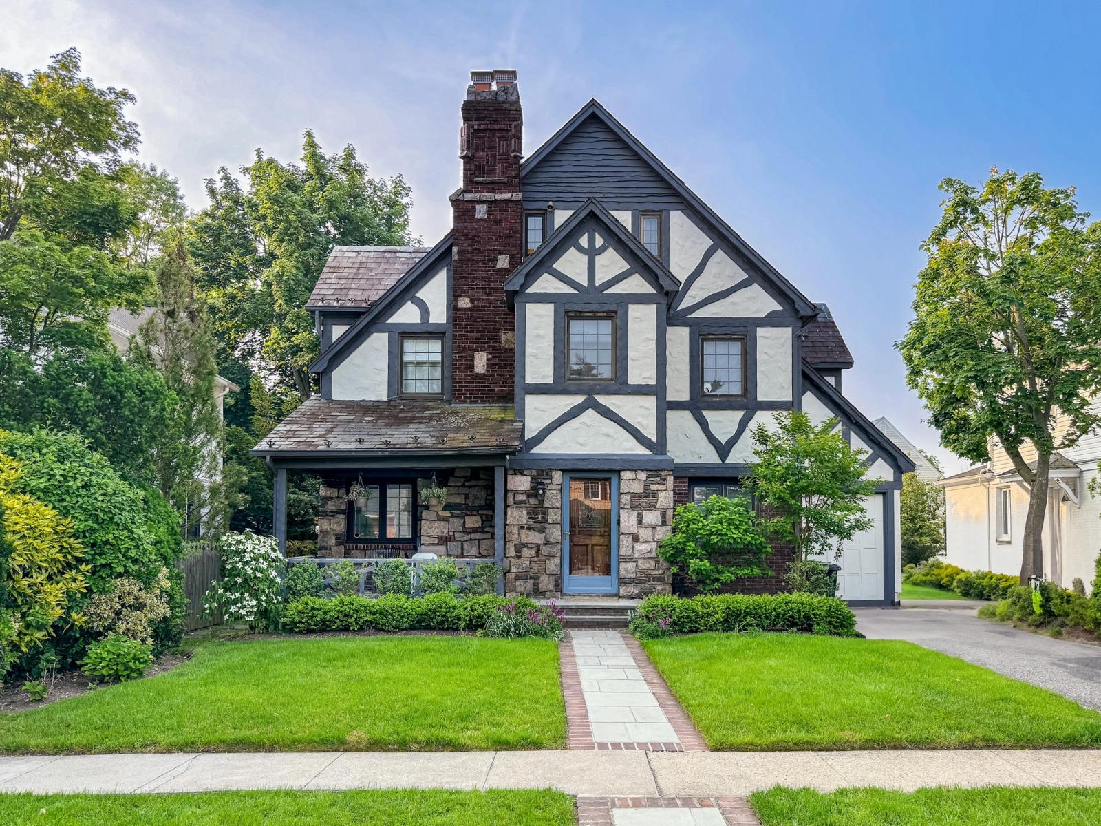 Tudor-style home with a stone porch and brick front walk, the kind of house Birmingham buyers can take their time on now