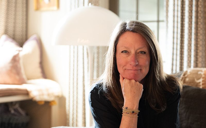 Mary Reed Durkin, founder of Mary Reed Durkin Real Estate, in a warmly lit portrait inside a Birmingham home.