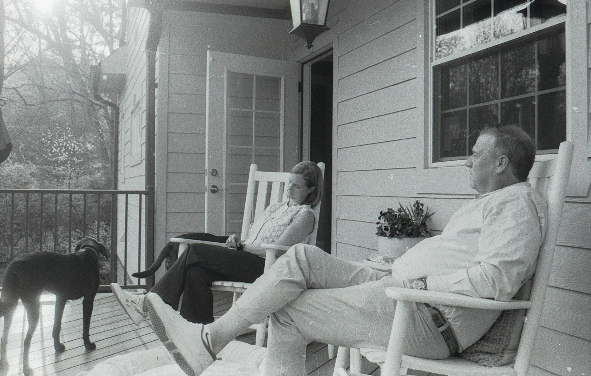 Couple on a residential porch resting with their dog, a warm portrait of established homeownership in Birmingham