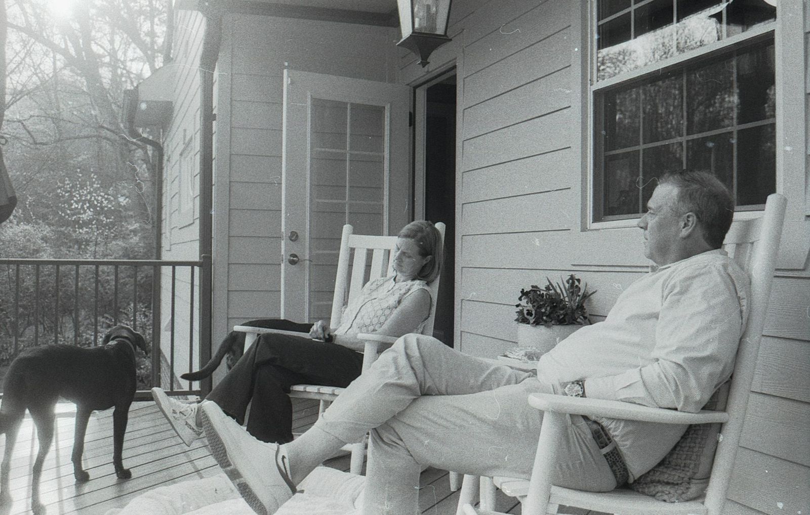 Couple on a residential porch resting with their dog, a warm portrait of established homeownership in Birmingham