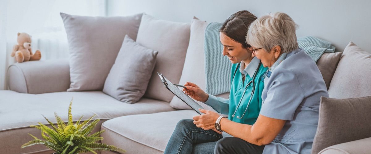 Elderly woman discussing home care plan with a trained professional