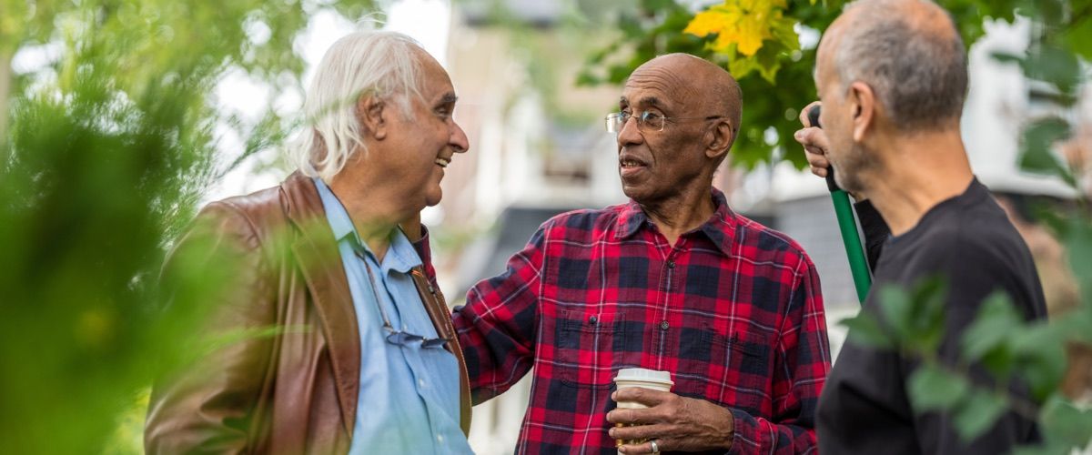3 seniors having fun talking in the yard