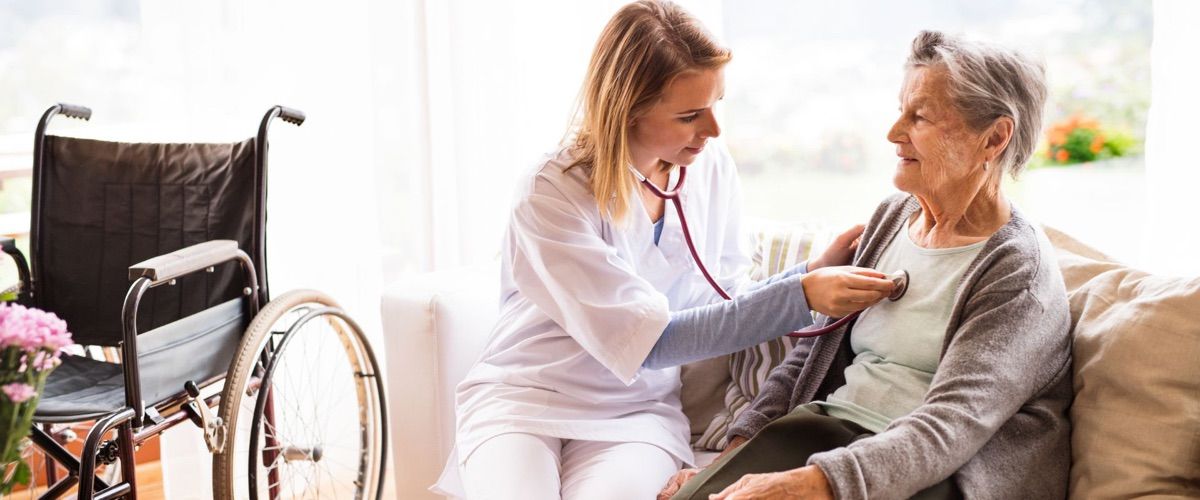Senior getting vitals checked by a registered nurse