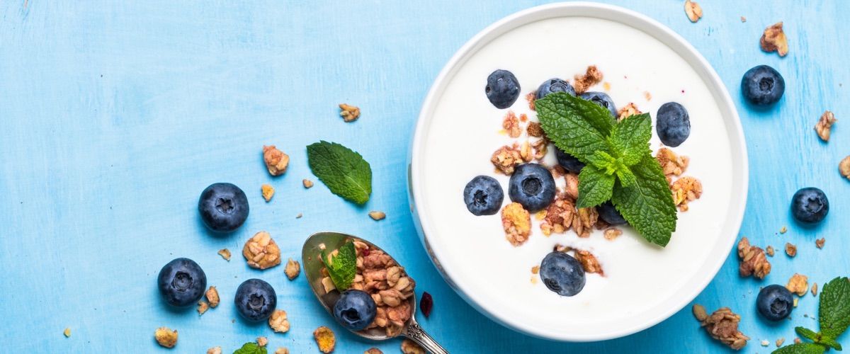 Blueberrys and yogurt with crumble and mint leaves