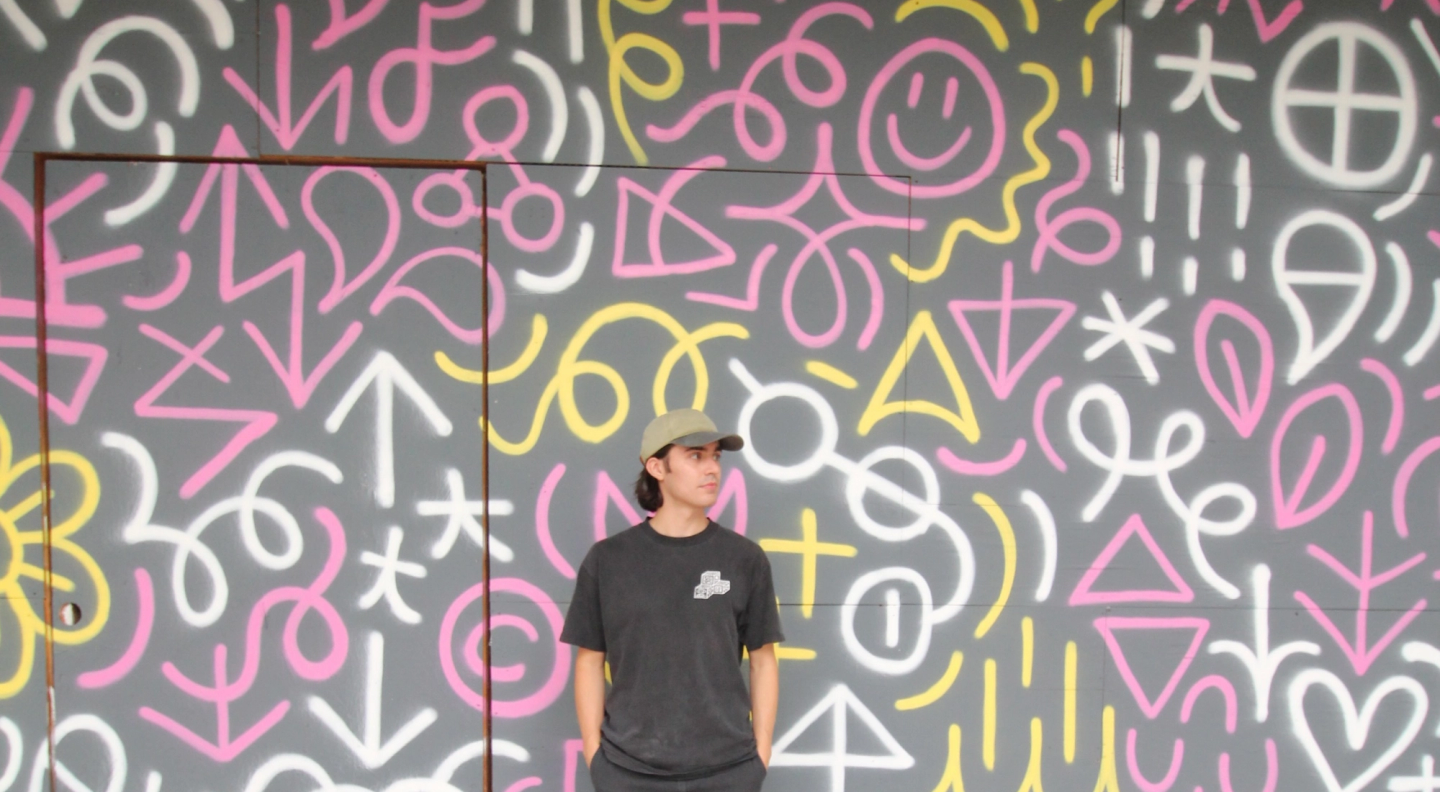 Image of Vinnie in front of his colorful Iconographic mural