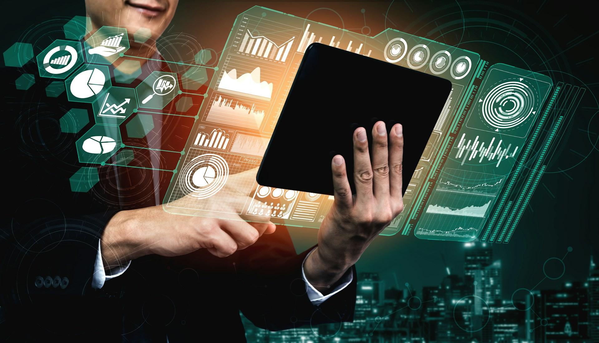 Businessman using a tablet with holographic charts, graphs, and data visualizations projected in the air.