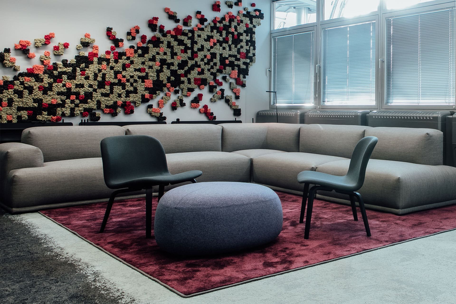 Sofa with red carpet and unusual wall installation
